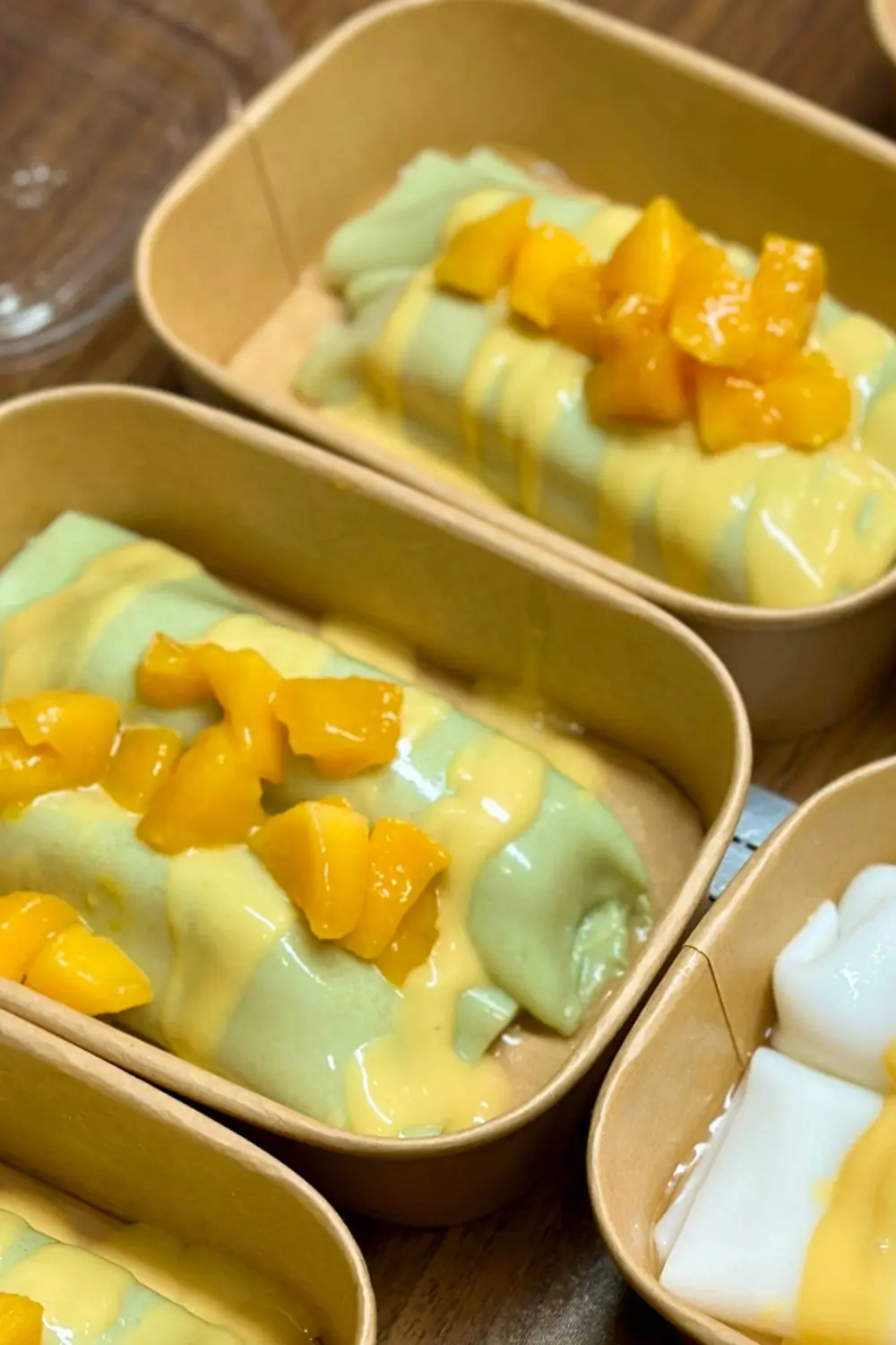 A plate of pandan - flavored rice noodle roll, with a unique green color and soft texture at Sweet Newbie,a Dessert Shop in Chicago